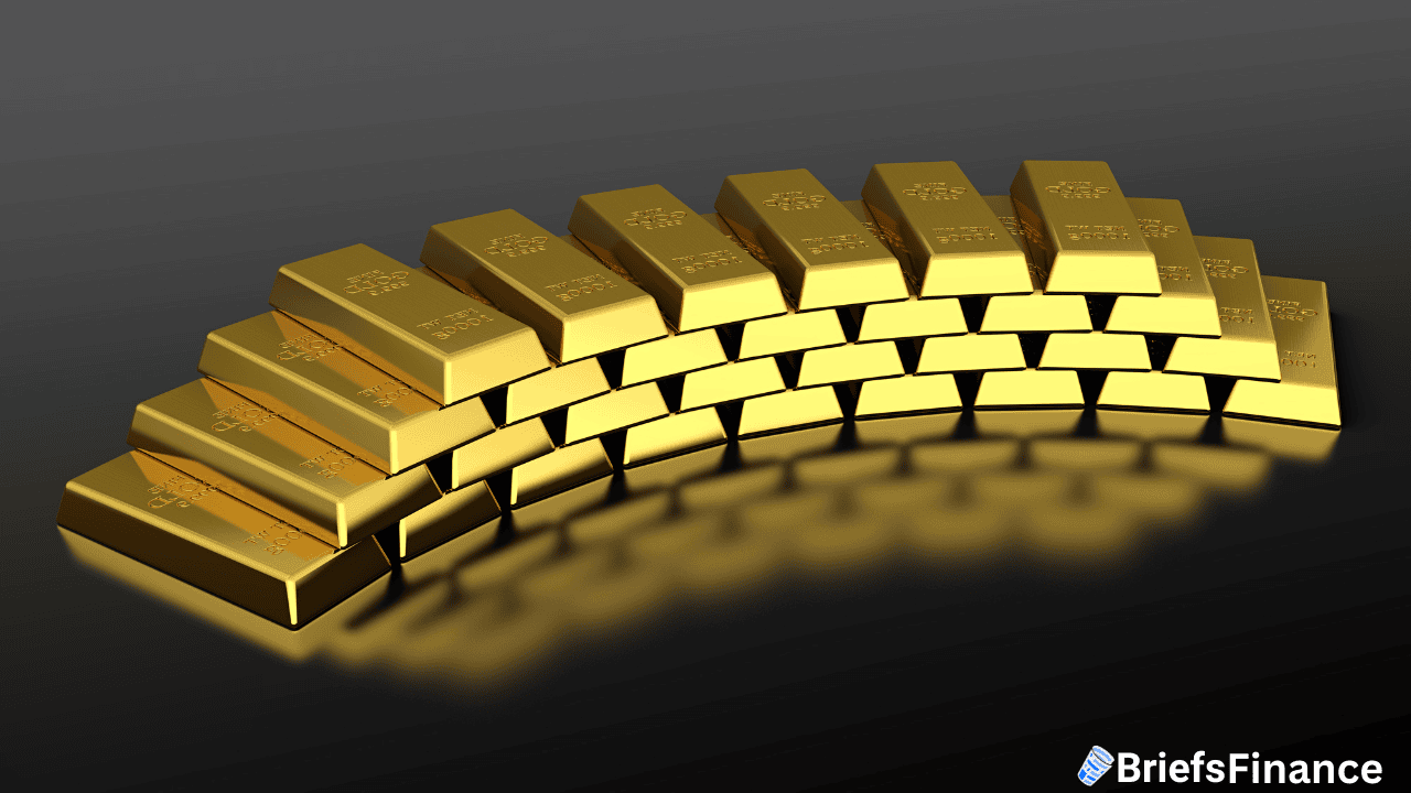 A curved stack of gold bars arranged in three rows on a dark surface with the BriefsFinance logo in the bottom right corner.