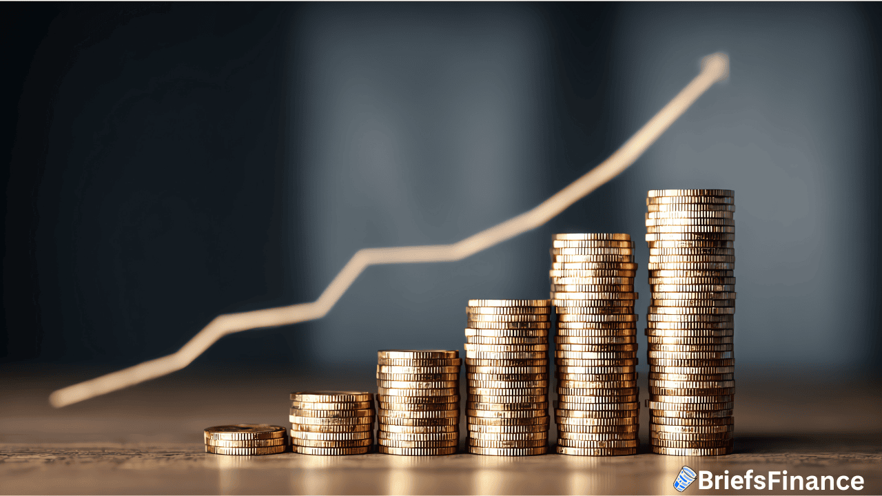 Stacks of gold coins arranged in ascending order with an upward-trending line graph above, indicating financial growth; "BriefsFinance" logo in the bottom right corner.