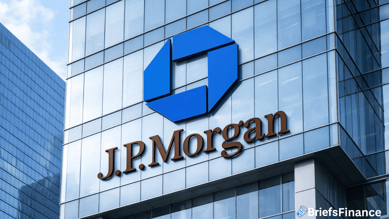 J.P. Morgan logo and name displayed on the glass facade of a modern office building with reflections of the sky and clouds.