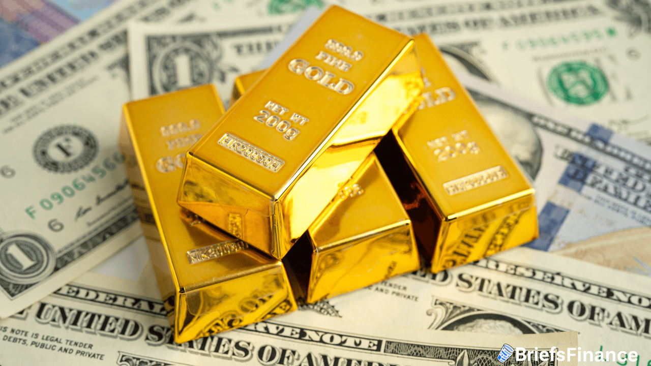 Five gold bars stacked on top of assorted US dollar bills, symbolizing wealth and financial assets.