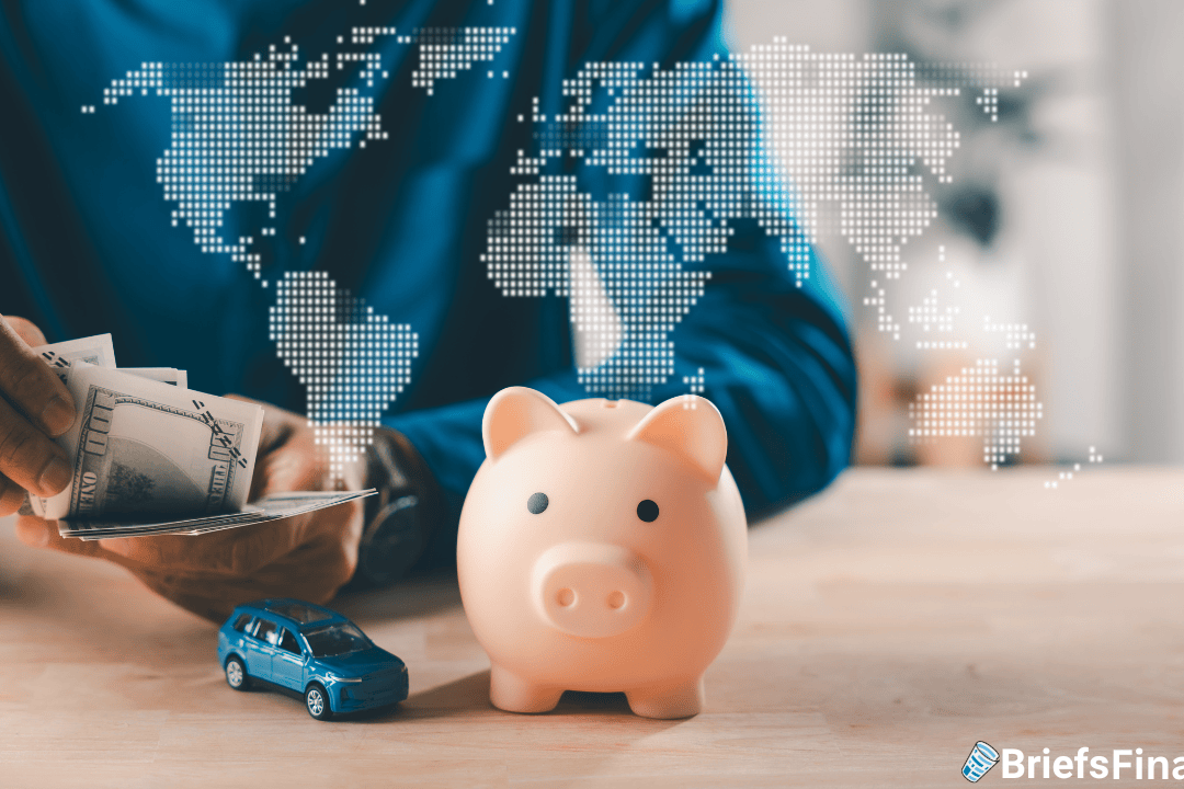 A person places cash near a pink piggy bank and a blue toy car, with a digital world map overlay in the background.